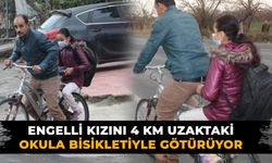 Her sabah bisikleti ile okula götürüyor
