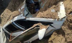Kum yüklü kamyonun otomobilin üzerine devrildi!